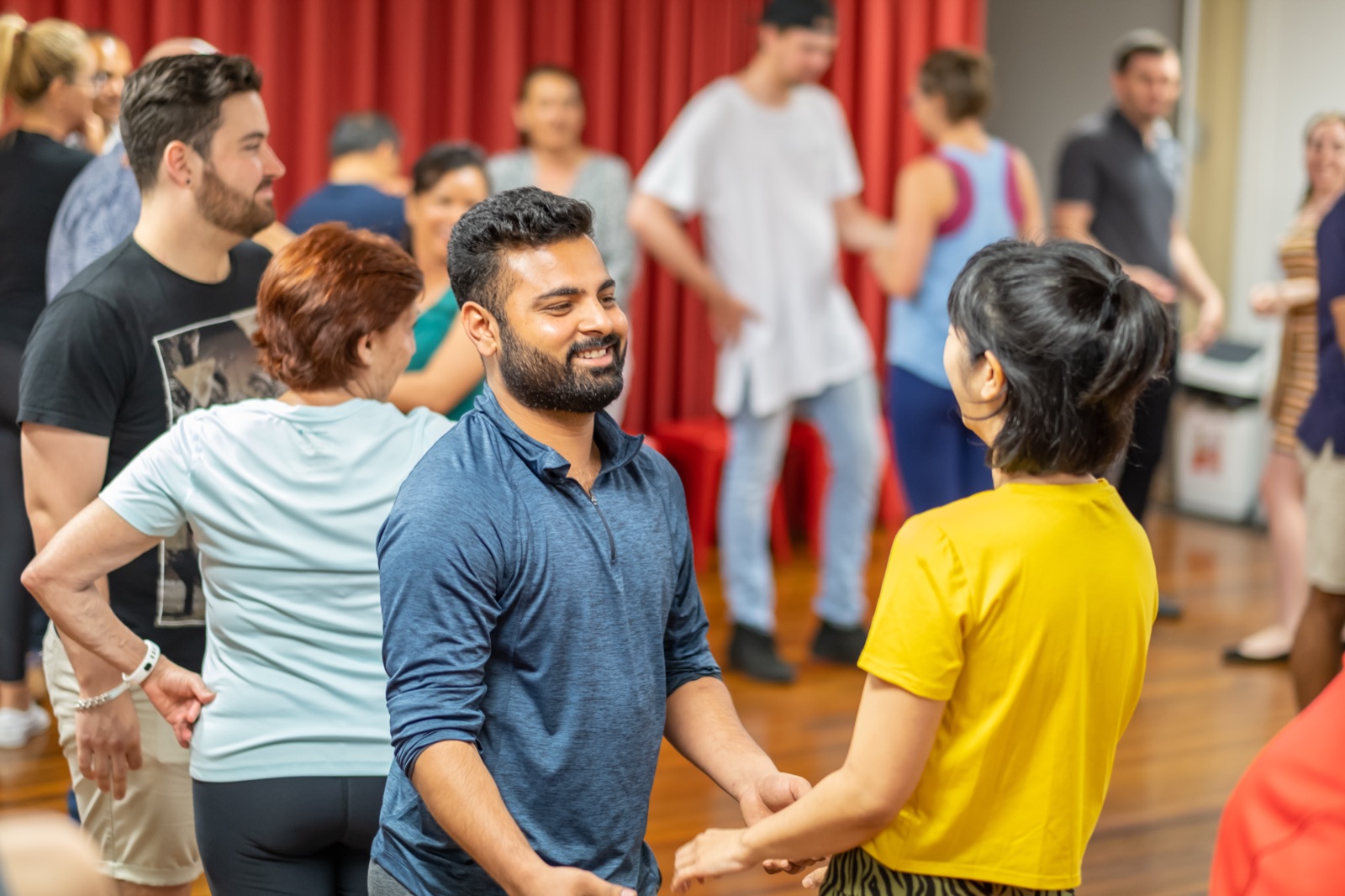 Students smiling as they rotate partners during class